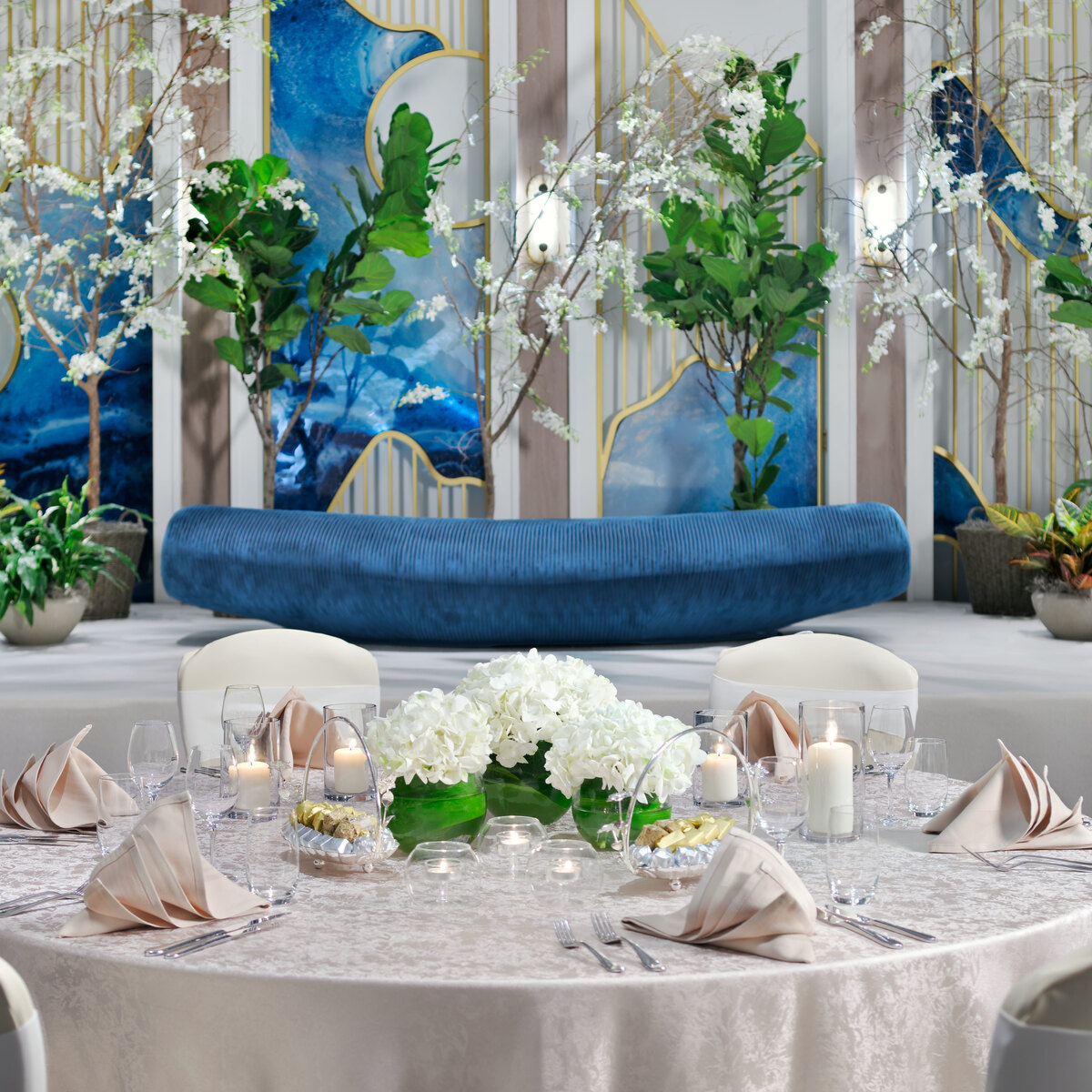 Round banquet table with a floral centerpiece and refined place settings at an H-Gourmet celebration